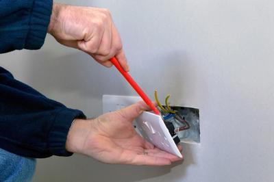 Borehamwood electrician fixing an electric socket